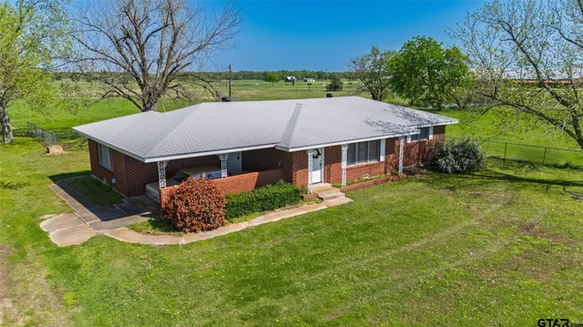 a living room with furniture ceiling fan and a window
