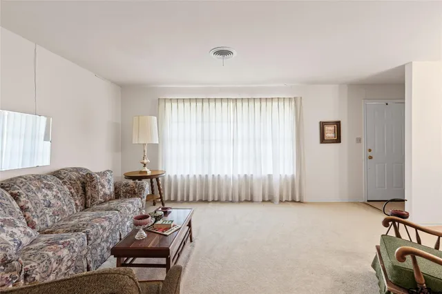 a living room with furniture and a lamp