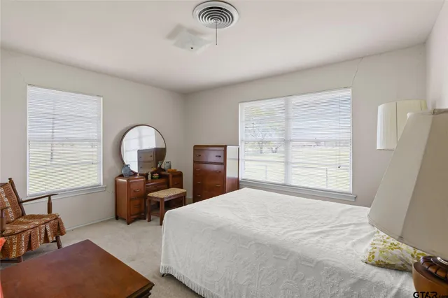 a bathroom with a sink toilet and mirror
