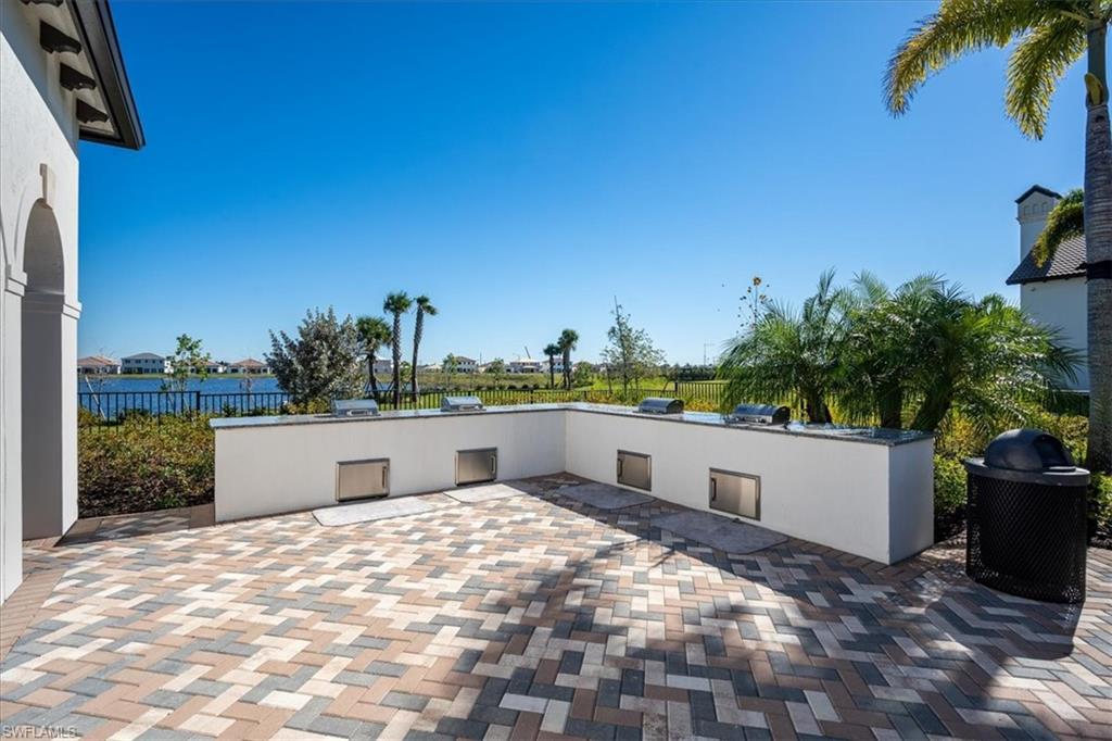 5547 Useppa Drive Ave Maria, FL 34142 - Photo 27 of 33 View of patio featuring an outdoor kitchen and fence