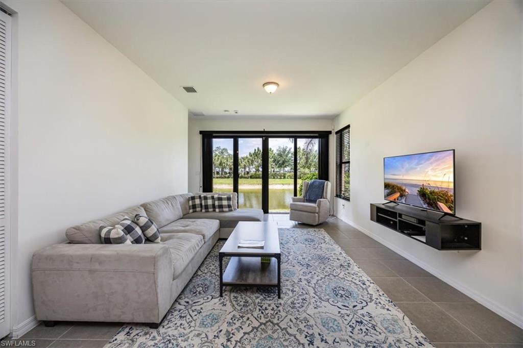 5547 Useppa Drive Ave Maria, FL 34142 - Photo 5 of 33 Tiled living area with baseboards and visible vents