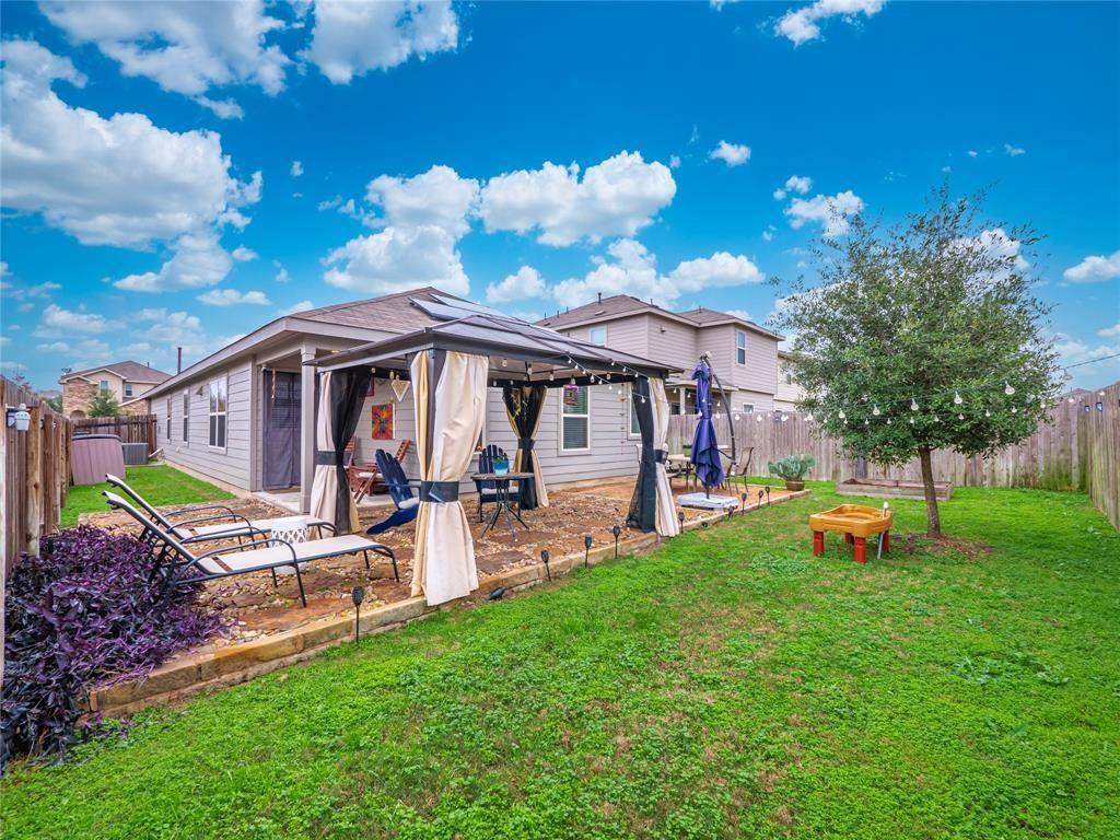 a view of a house with backyard porch and sitting area