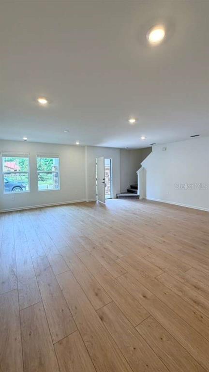 5174 Clay Whaley Road St. Cloud, FL 34772 - Photo 4 of 25 a view of empty room with wooden floor and fan