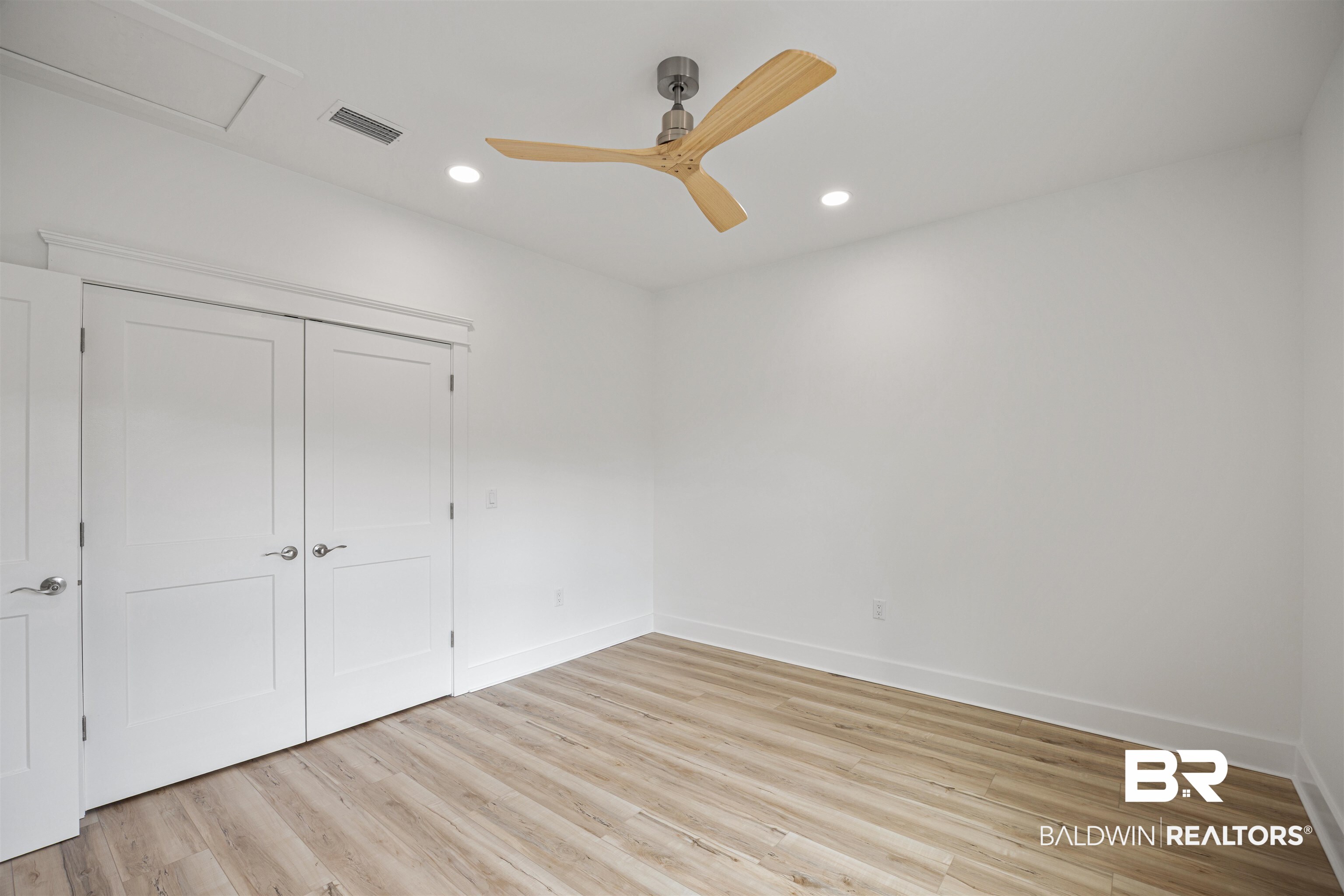 27591 Canal Road Orange Beach, AL 36561 - Photo 38 of 51 Unfurnished bedroom featuring light wood-style floors, recessed lighting, ceiling fan, and a closet