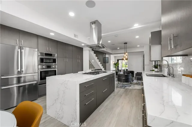 a kitchen with stainless steel appliances granite countertop a sink refrigerator and cabinets