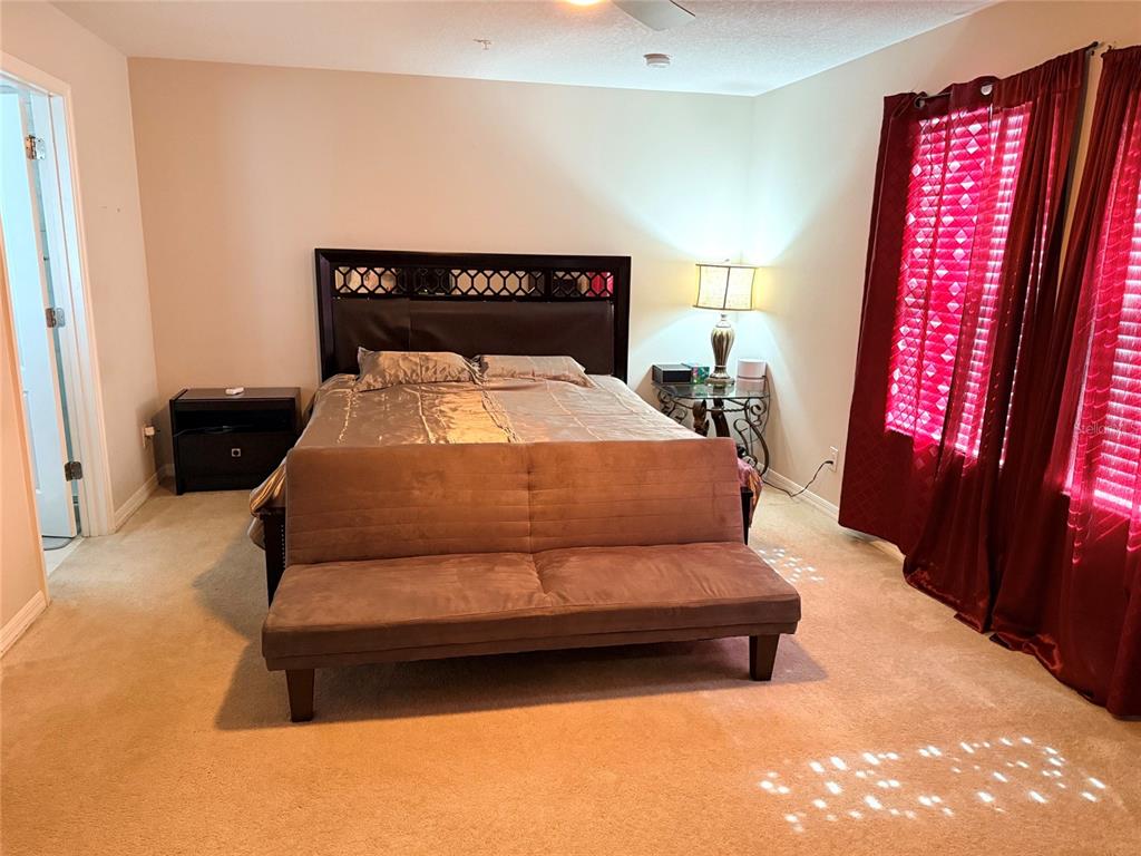 2084 Water Tupelo Way Ocoee, FL 34761 - Photo 14 of 34 a bedroom with a bed and window