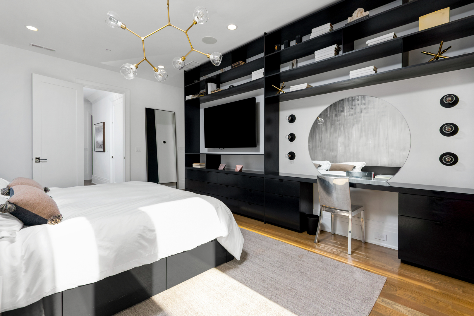 453 West Deming Place Chicago, IL 60614 - Photo 18 of 50 a spacious bedroom with a bed a mirror and a flat tv screen on a dresser