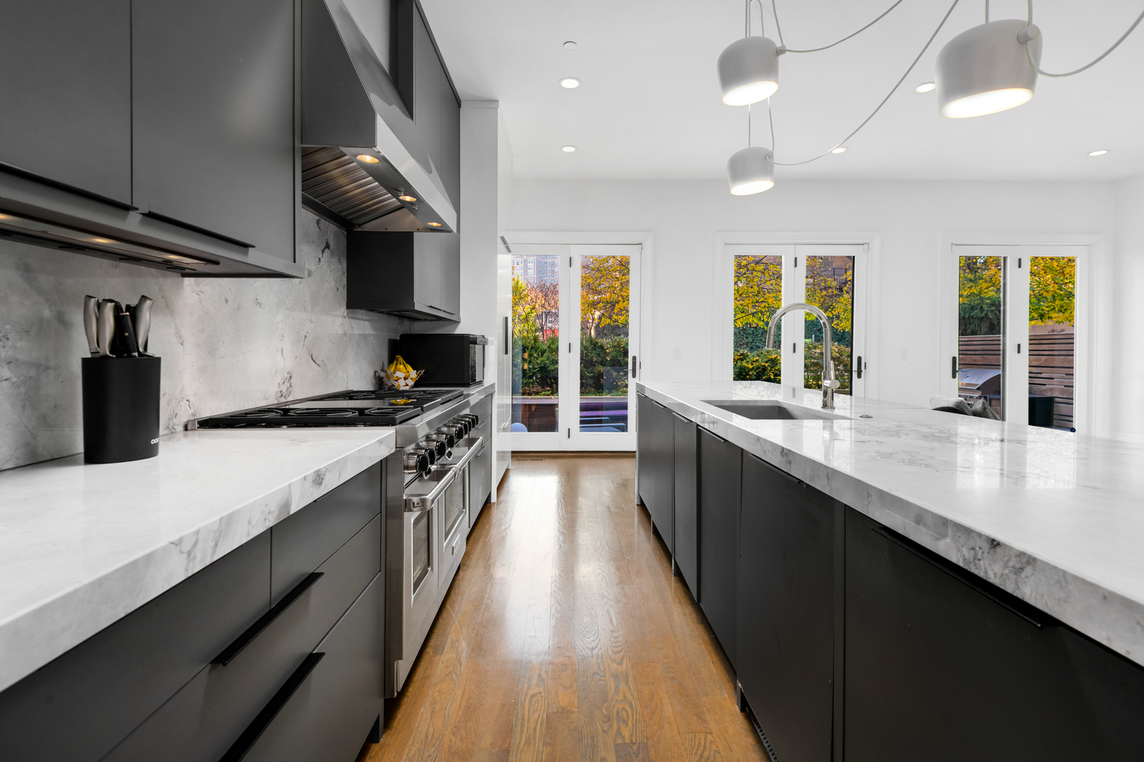 453 West Deming Place Chicago, IL 60614 - Photo 9 of 50 a large kitchen with stainless steel appliances a large counter top a stove and a sink