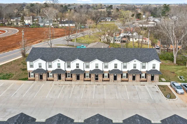 a view of houses with a yard