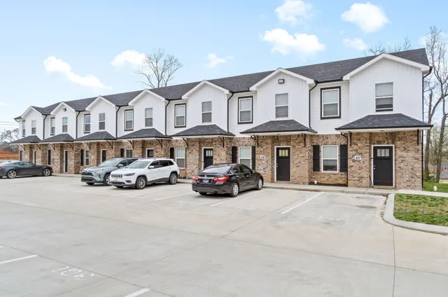 a car parked in front of a white building