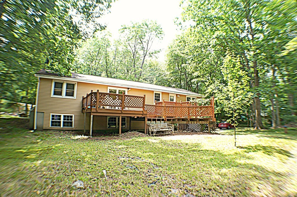 13 Woodland Road Windham, NH 03087 - Photo 3 of 23 a front view of a house with a yard