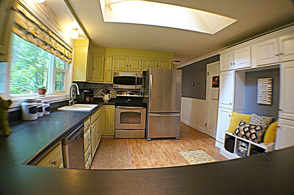 13 Woodland Road Windham, NH 03087 - Photo 7 of 23 a kitchen with stainless steel appliances a stove sink refrigerator and a microwave