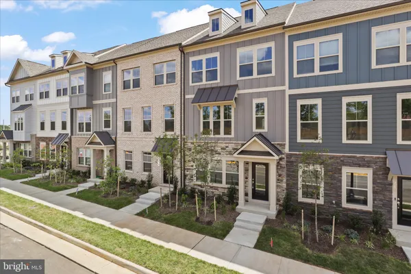 a front view of a residential apartment building with a yard