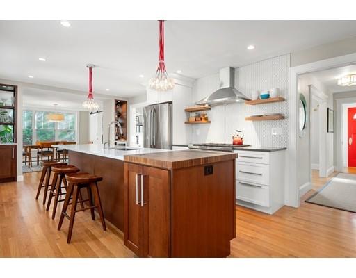 45 Avon Road Wellesley, MA 02482 - Photo 3 of 31 a kitchen with stainless steel appliances kitchen island granite countertop a table chairs and a refrigerator