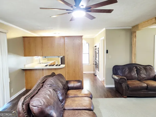 a living room with furniture and a wooden floor