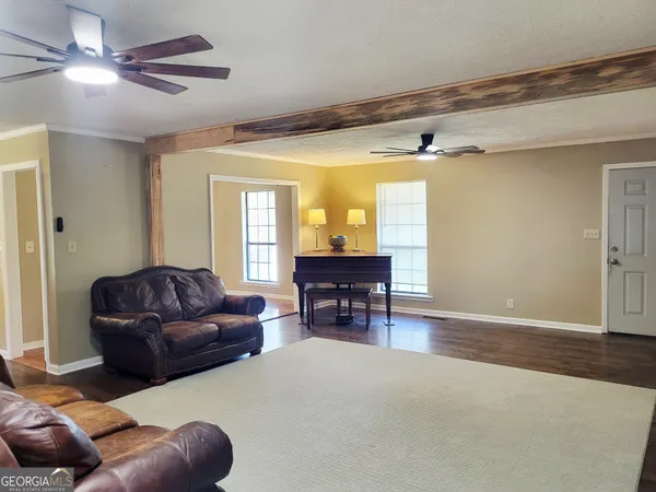 a living room with furniture and a dining table