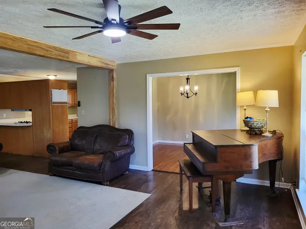 a living room with furniture and a chandelier