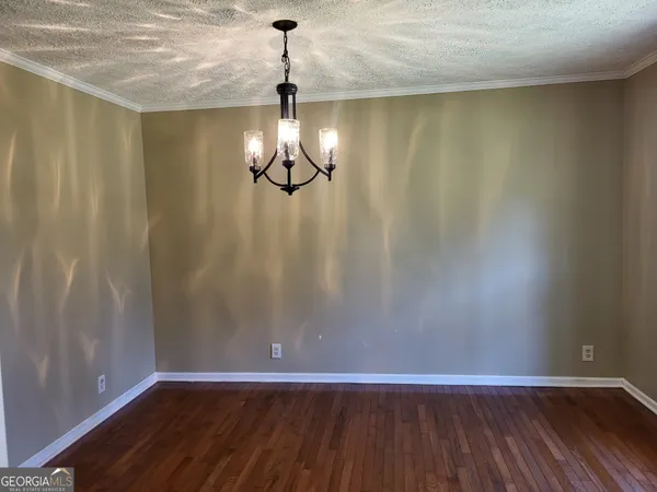 a view of a room with wooden floor