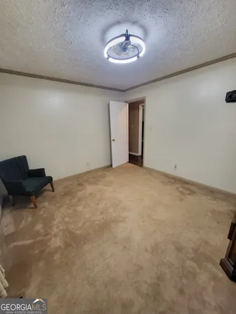 a view of room with a ceiling fan and couch