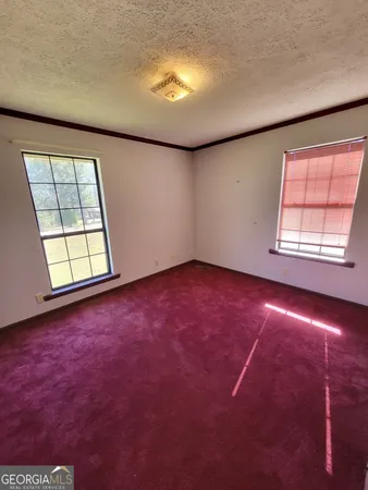 an empty room with a empty space and windows