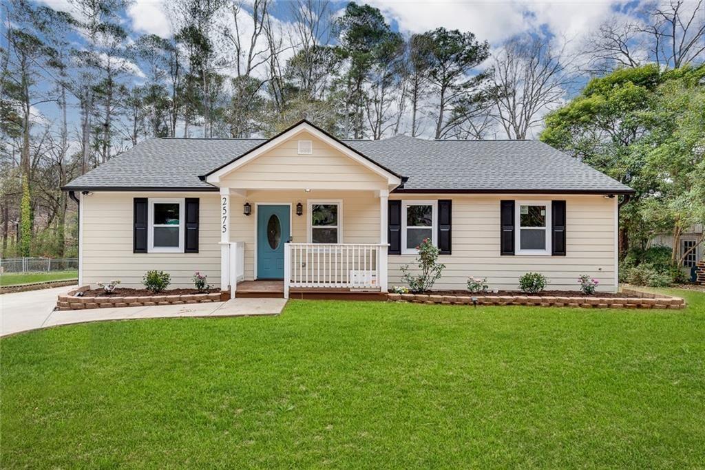 a front view of a house with a yard and porch