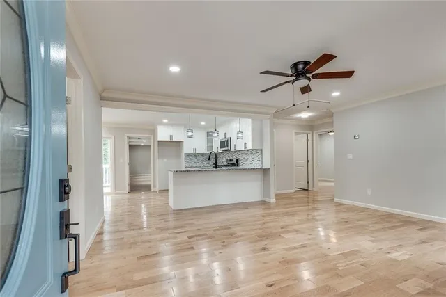 a view of a kitchen with a refrigerator and a chandelier