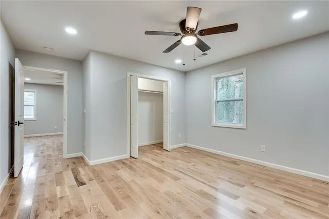 a view of a livingroom with a ceiling fan and window