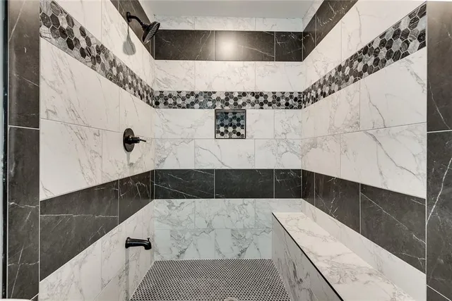 a bathroom with a bathtub and shower