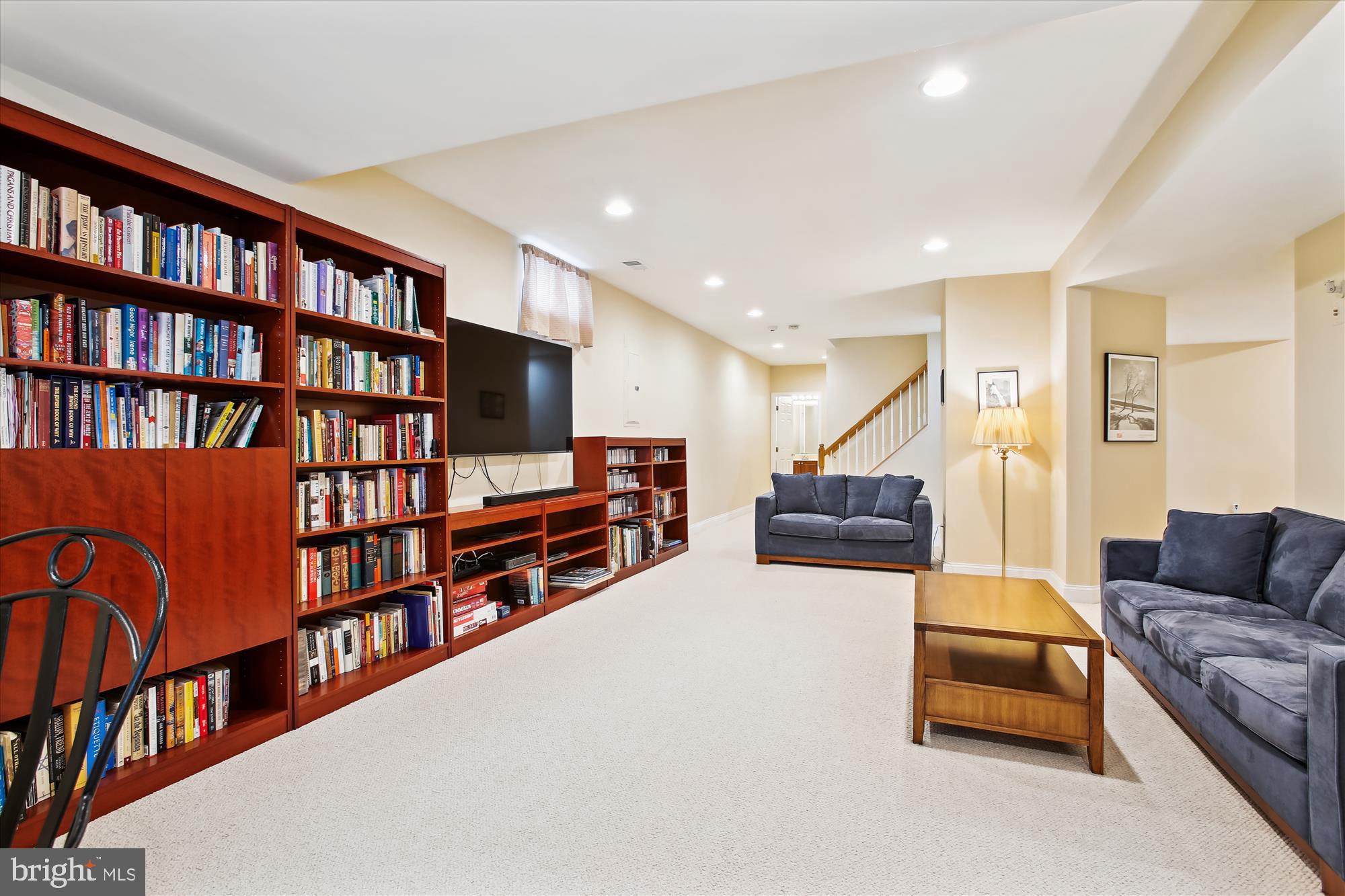 22902 North Brown Square Ashburn, VA 20148 - Photo 43 of 70 a living room with furniture and a book shelf