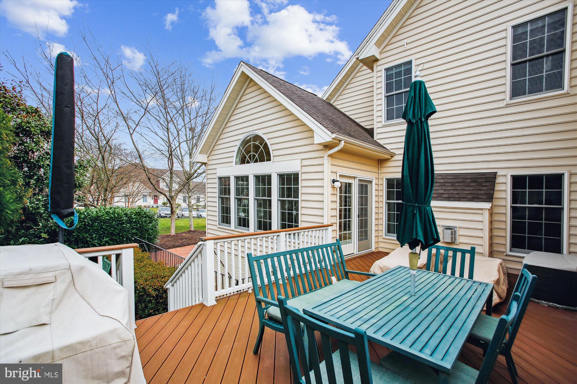 22902 North Brown Square Ashburn, VA 20148 - Photo 53 of 70 a view of a house with a wooden deck and furniture