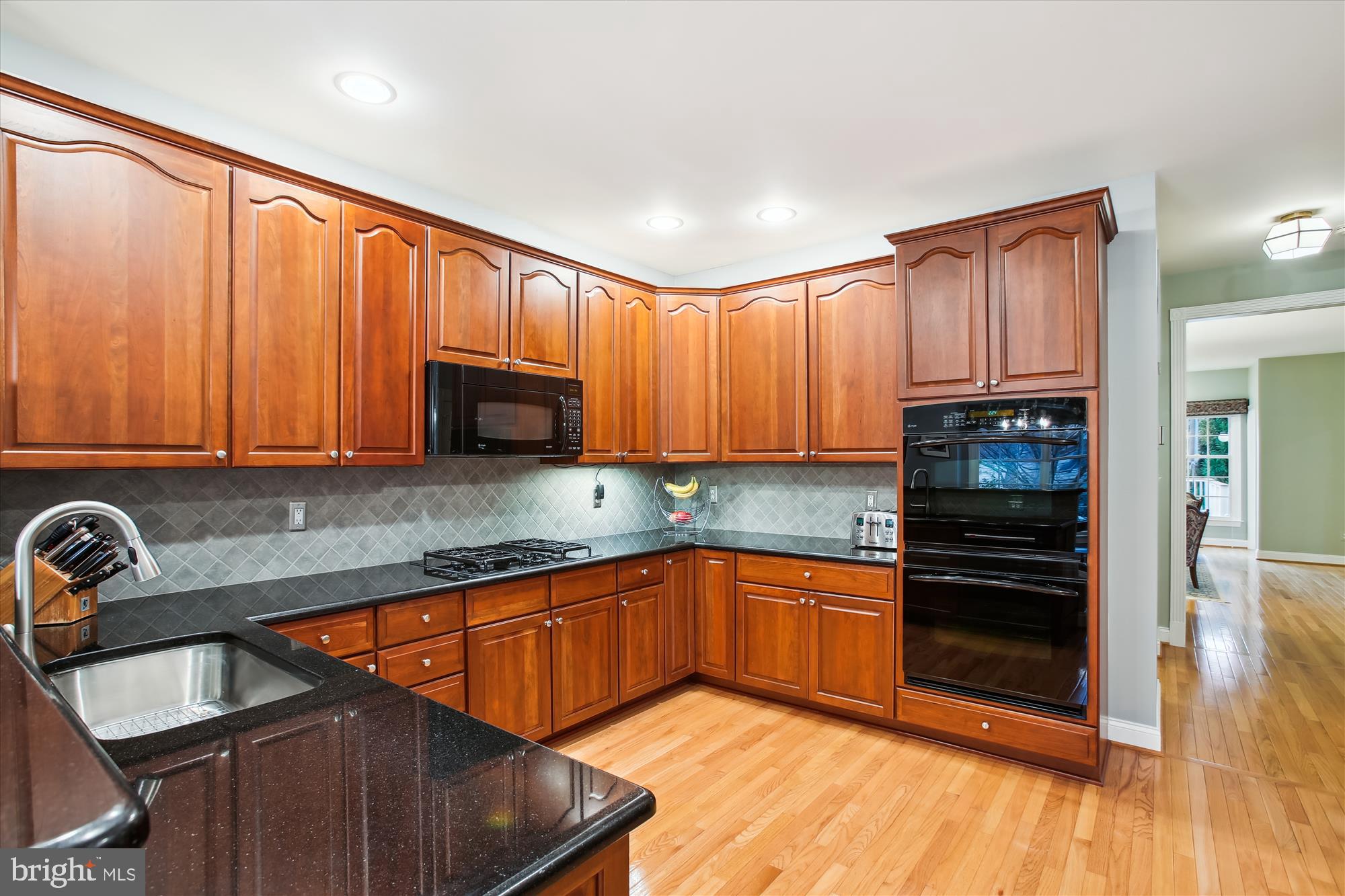 22902 North Brown Square Ashburn, VA 20148 - Photo 8 of 70 a kitchen with granite countertop a stove top oven sink and cabinets