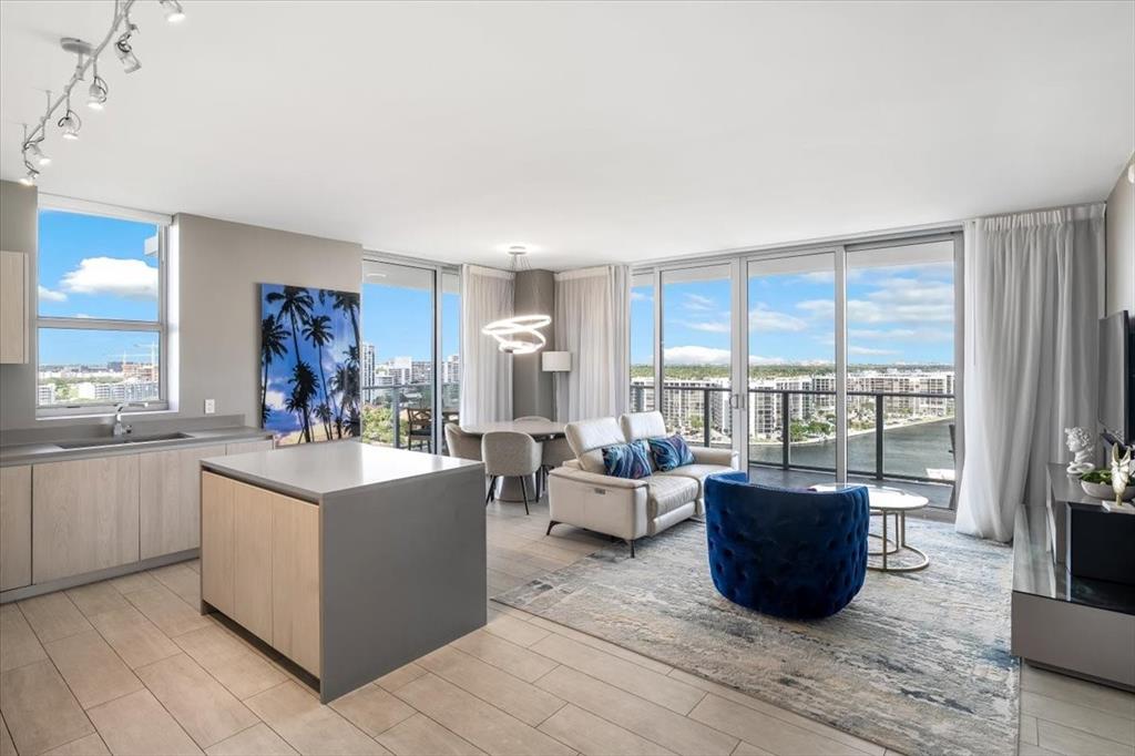 4010 South Ocean Drive, Unit R1102 Hollywood, FL 33019 - Photo 11 of 47 a living room with furniture a large window and a kitchen view
