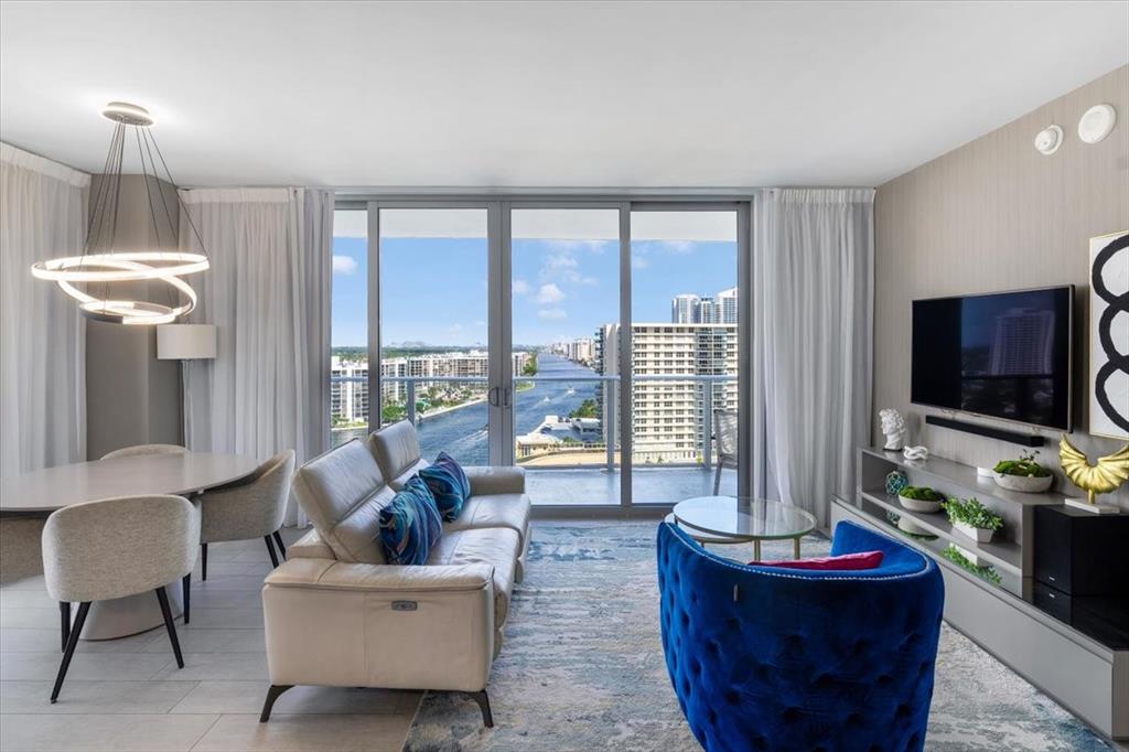 4010 South Ocean Drive, Unit R1102 Hollywood, FL 33019 - Photo 13 of 47 a living room with fireplace furniture and a flat screen tv