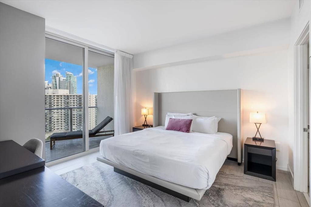 4010 South Ocean Drive, Unit R1102 Hollywood, FL 33019 - Photo 21 of 47 a bedroom with a bed and wooden floor