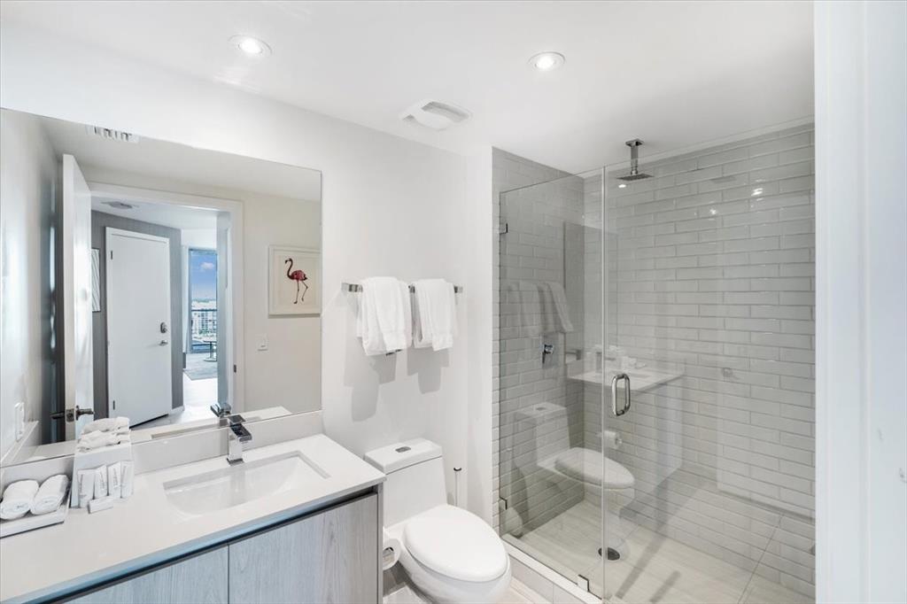 4010 South Ocean Drive, Unit R1102 Hollywood, FL 33019 - Photo 28 of 47 a bathroom with a sink toilet a mirror and shower