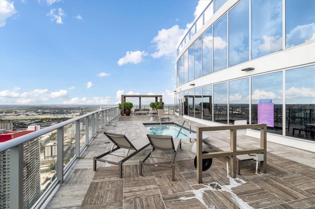 4010 South Ocean Drive, Unit R1102 Hollywood, FL 33019 - Photo 33 of 47 a view of a patio with a dining table and chairs with wooden floor