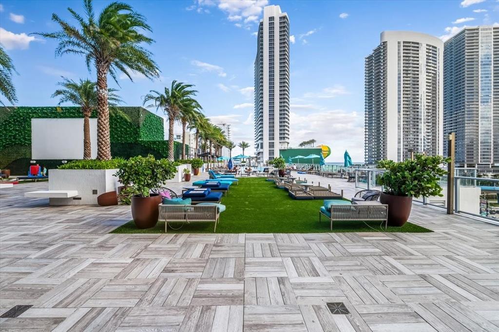 4010 South Ocean Drive, Unit R1102 Hollywood, FL 33019 - Photo 41 of 47 a view of a patio with couches and a potted plant on a floor