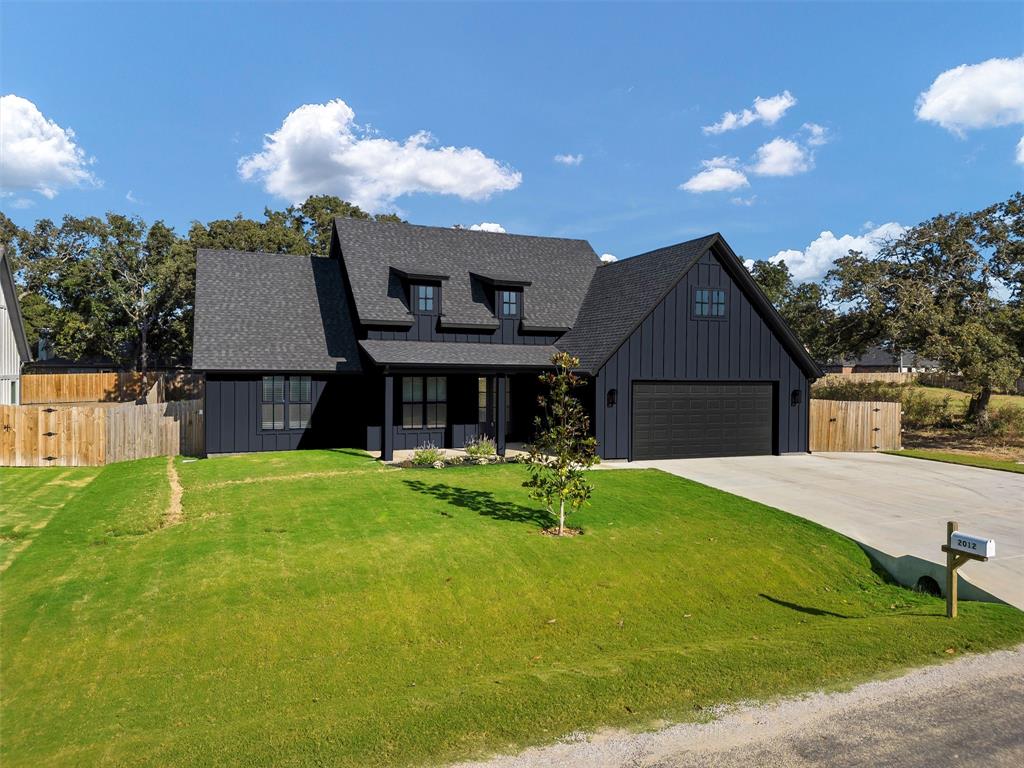 a front view of house with a garden and patio
