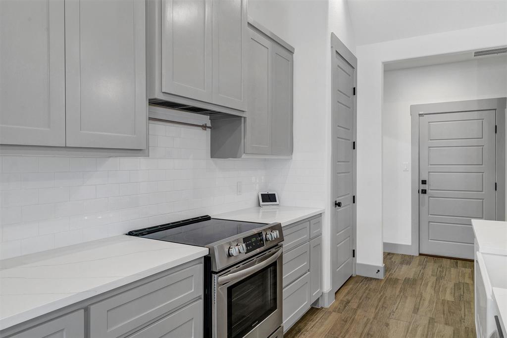 2029 Rattler Way Tolar, TX 76476 - Photo 14 of 28 a kitchen with a stove and a microwave