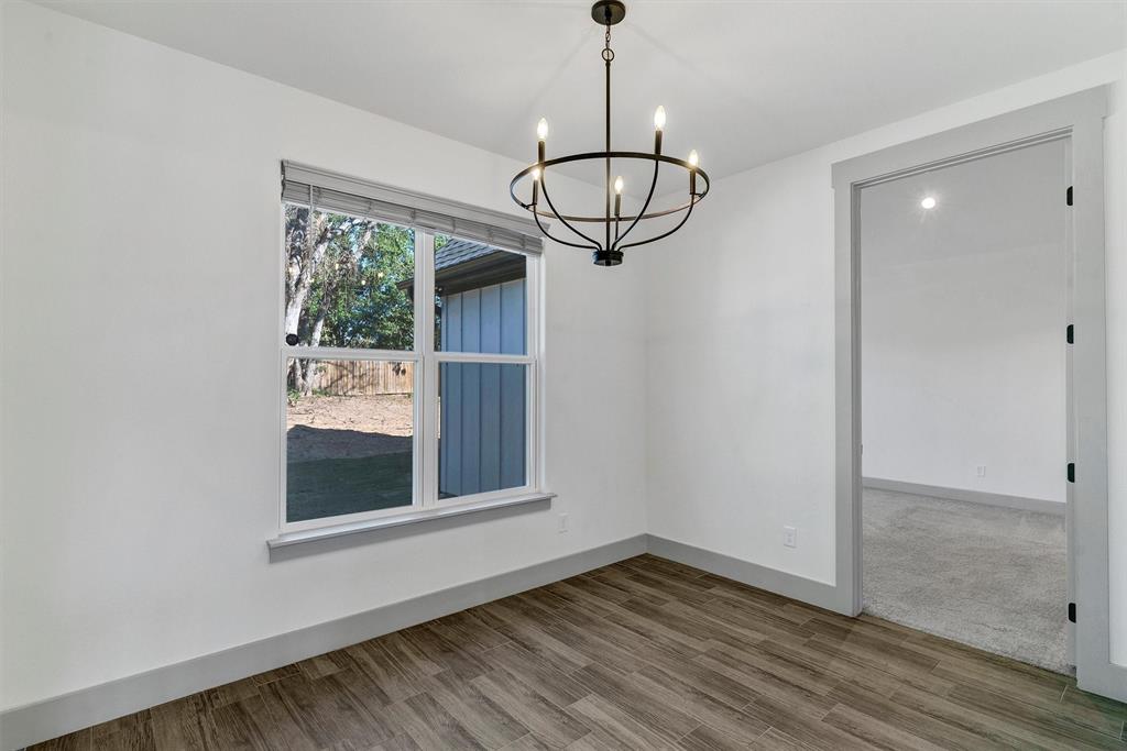 2029 Rattler Way Tolar, TX 76476 - Photo 16 of 28 a view of wooden floor and a chandelier in a room