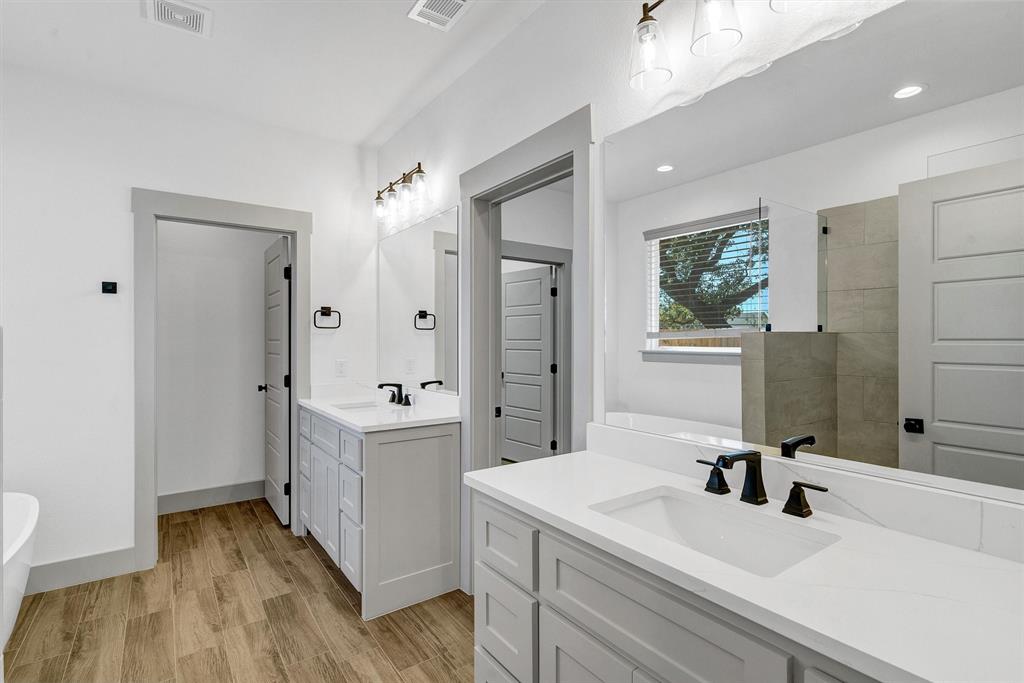 2029 Rattler Way Tolar, TX 76476 - Photo 20 of 28 a bathroom with a sink a mirror and a shower