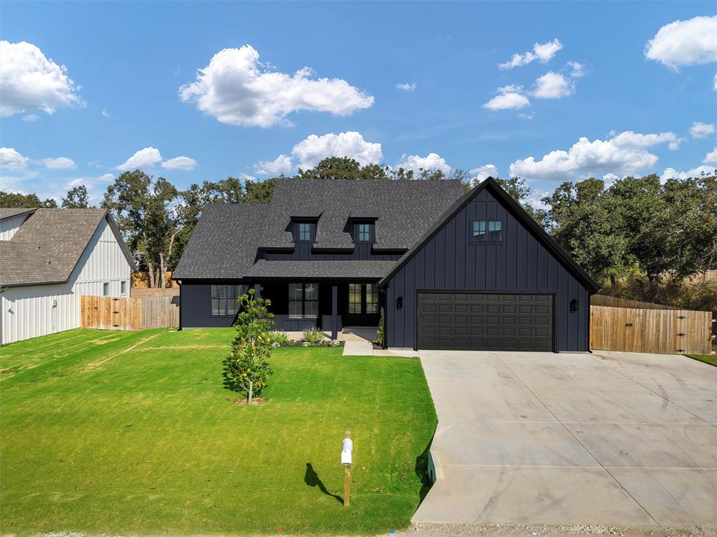 2029 Rattler Way Tolar, TX 76476 - Photo 2 of 28 a front view of a house with garden