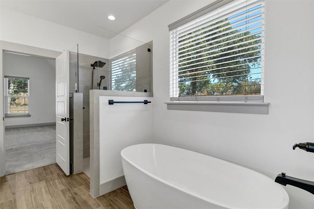 2029 Rattler Way Tolar, TX 76476 - Photo 21 of 28 a white bath tub sitting in a bathroom next to a window