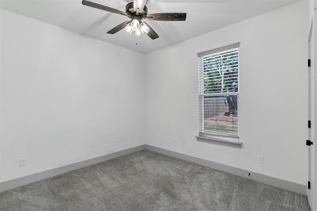 2029 Rattler Way Tolar, TX 76476 - Photo 23 of 28 an empty room with windows and fan
