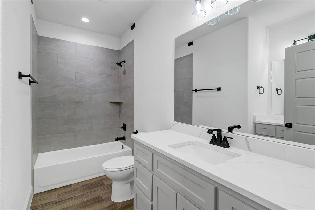 2029 Rattler Way Tolar, TX 76476 - Photo 24 of 28 a bathroom with a sink a toilet and a bathtub