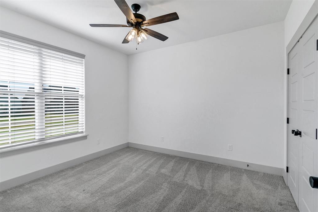 2029 Rattler Way Tolar, TX 76476 - Photo 26 of 28 an empty room with a window and a fan