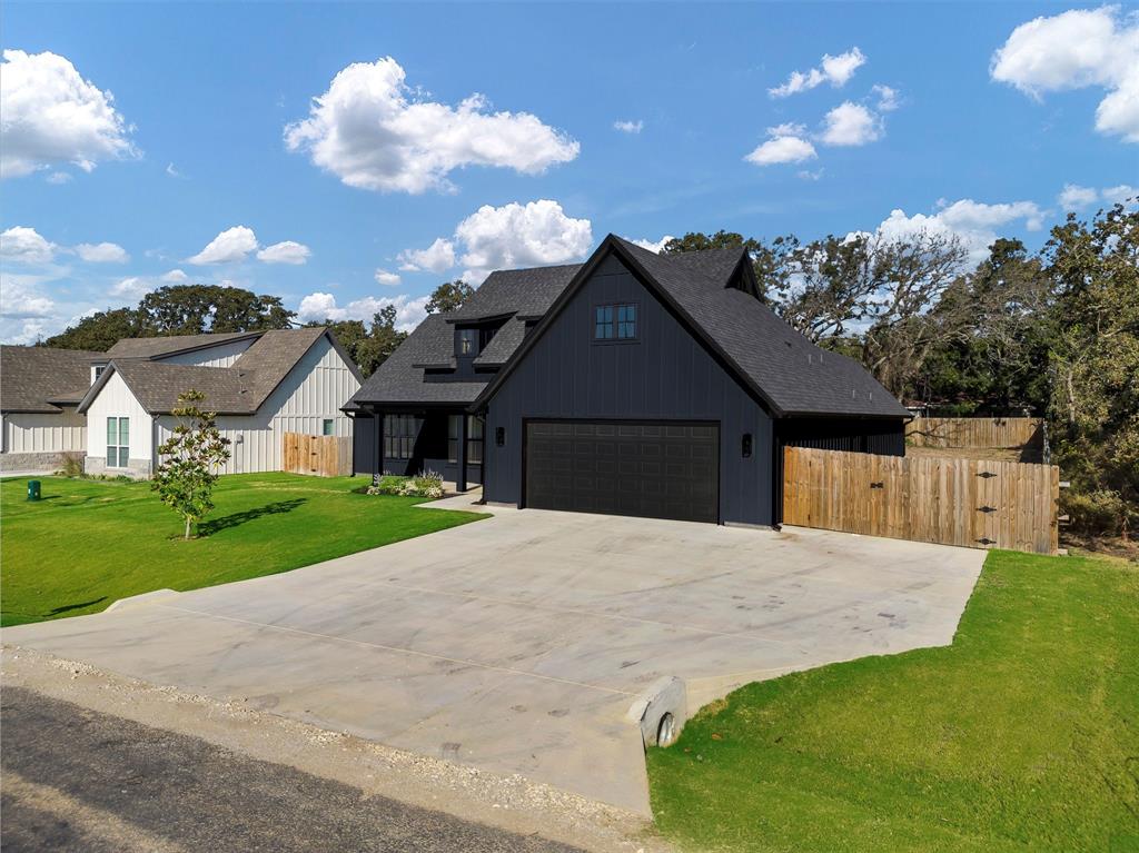 2029 Rattler Way Tolar, TX 76476 - Photo 3 of 28 a front view of a house with a yard and garage