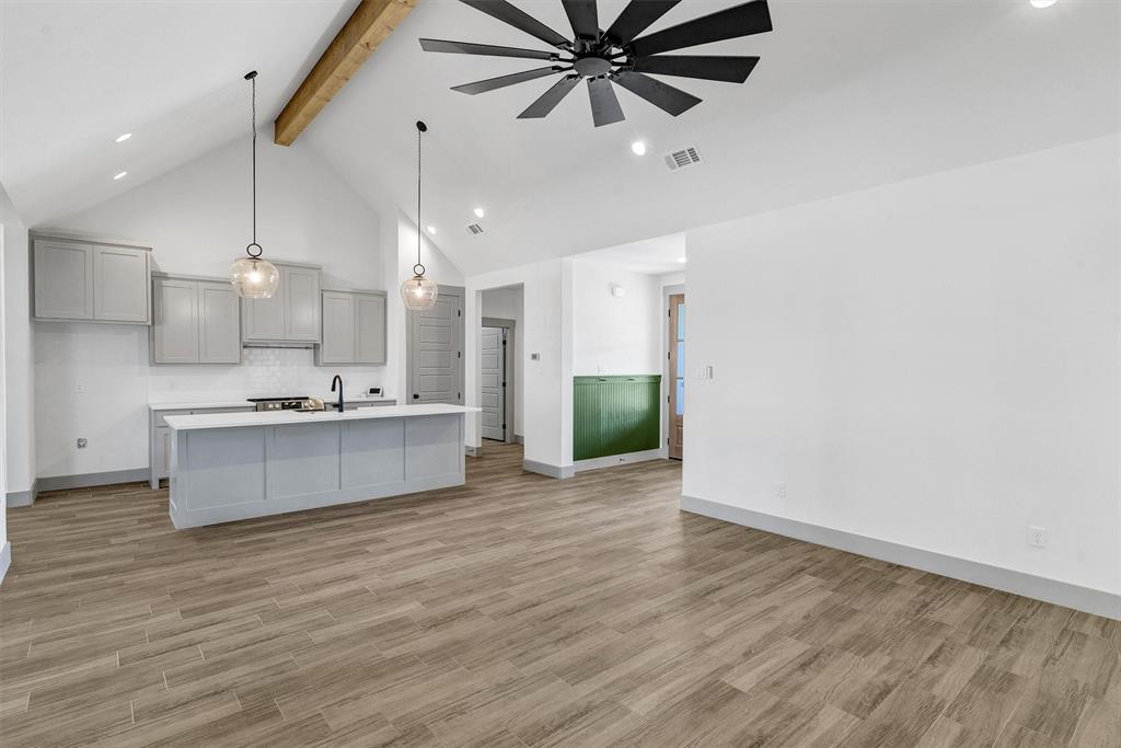 2029 Rattler Way Tolar, TX 76476 - Photo 6 of 28 a large kitchen with kitchen island a sink stainless steel appliances and cabinets