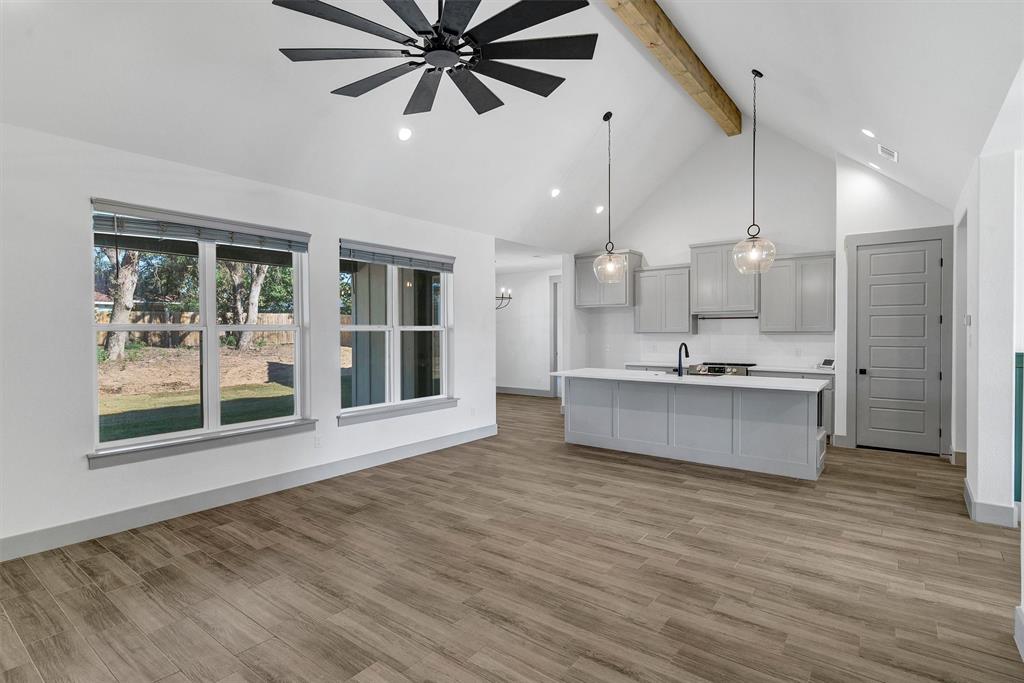2029 Rattler Way Tolar, TX 76476 - Photo 7 of 28 a large kitchen with a large counter top a sink stainless steel appliances and cabinets