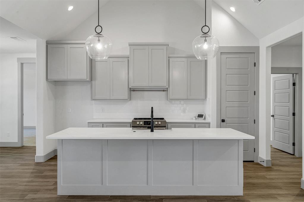 2029 Rattler Way Tolar, TX 76476 - Photo 10 of 28 a kitchen with kitchen island granite countertop a sink cabinets and stainless steel appliances
